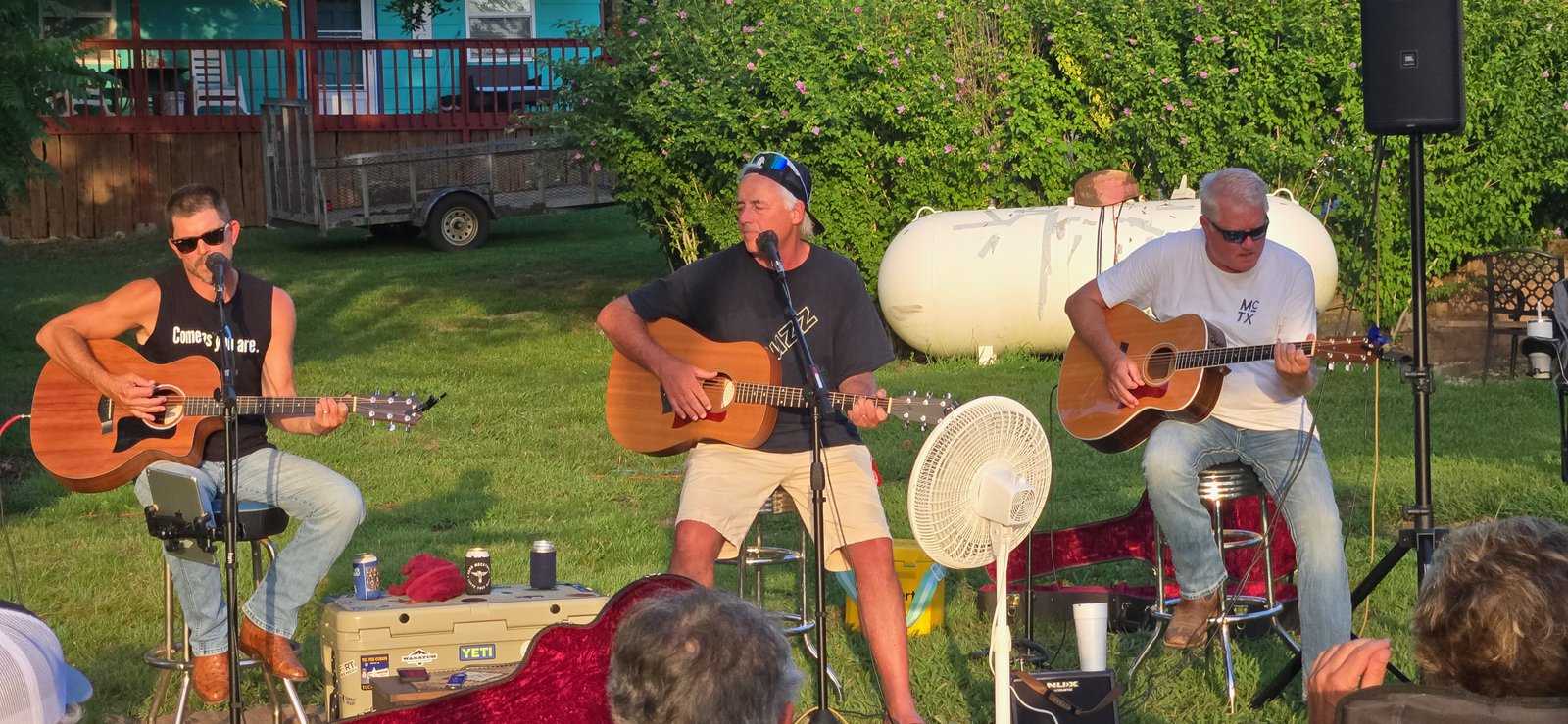 Chad McCutchen, Capt. Bill, and Greg Ryan playing acoustic guitars at Jack's Resort