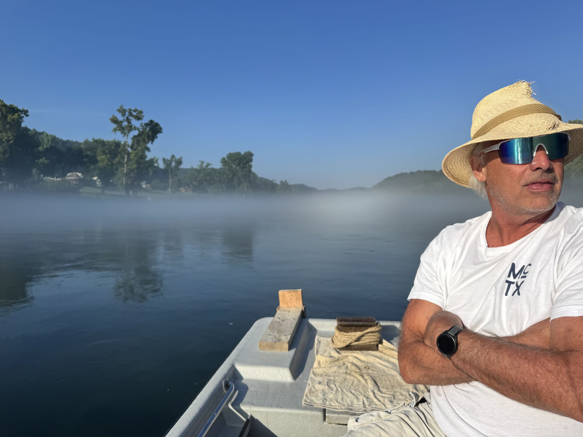 Early morning on the White River — cold tailwater fog rising into a July sky.