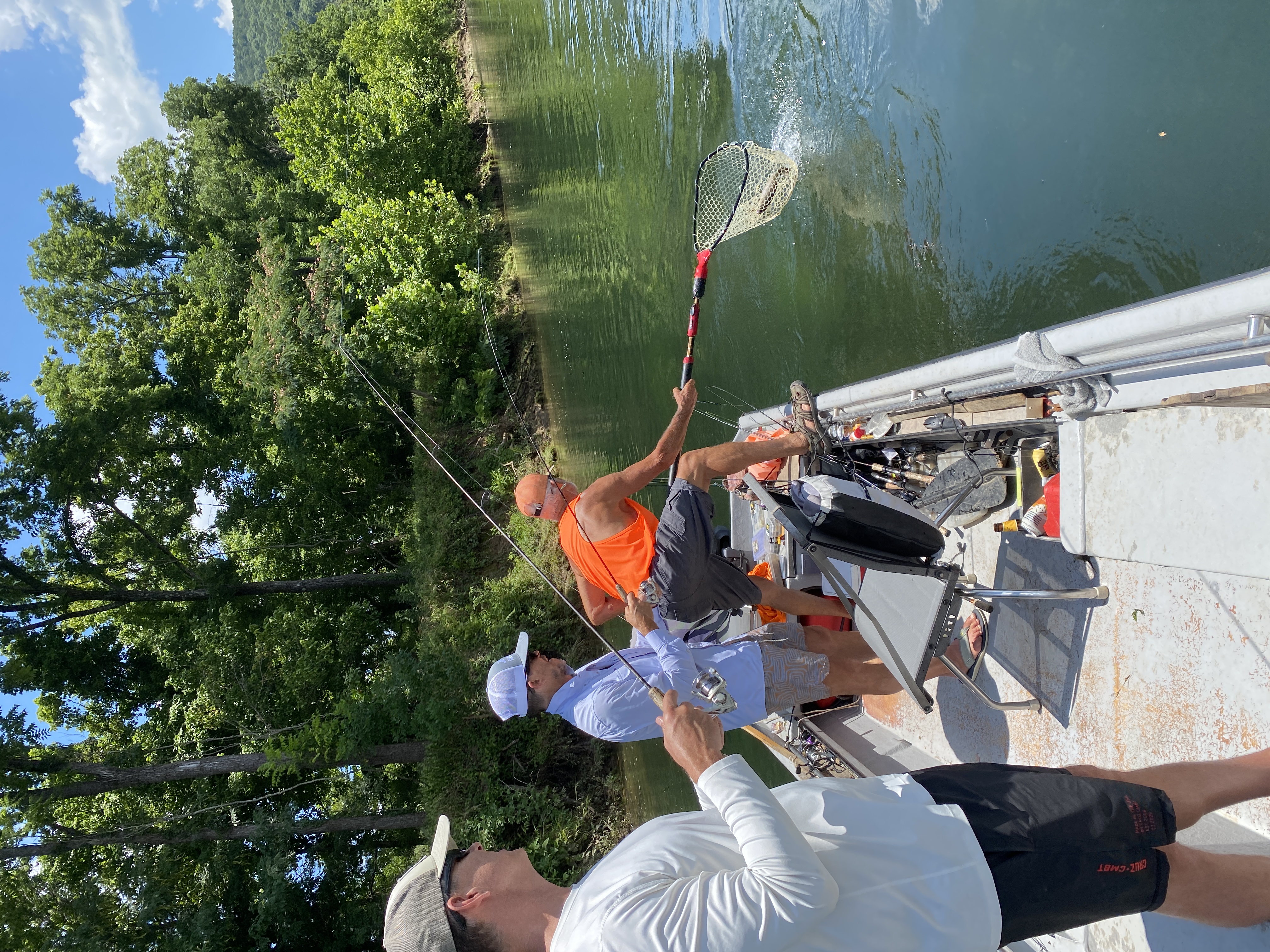 Netting a rainbow trout on the White River float — the boat on the move.